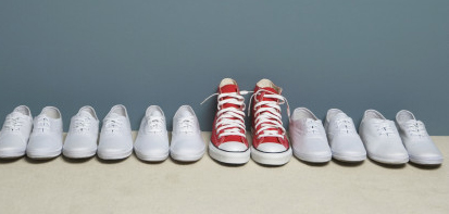 a row of shoes, one pair is different- change makers are different